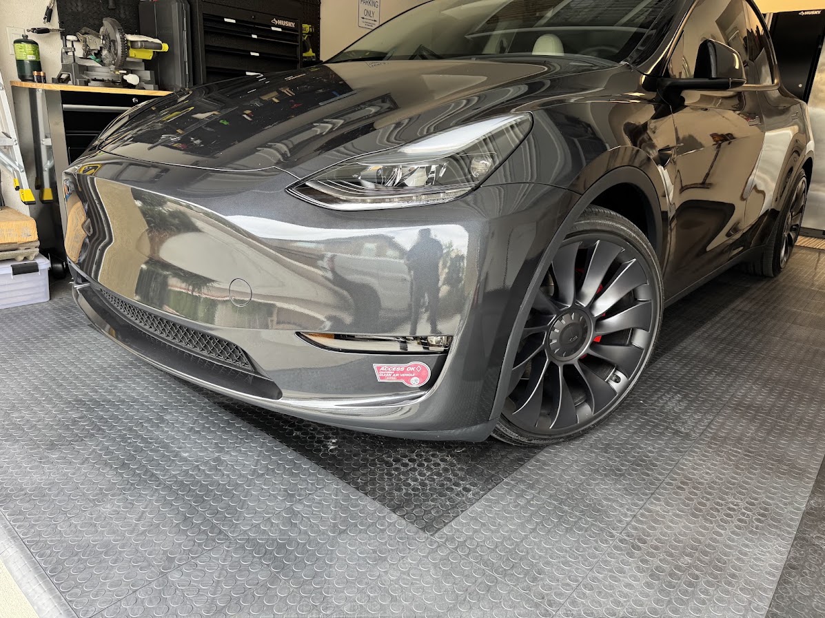 Finished Midnight Silver Tesla Model Y front bumper and fender after repair