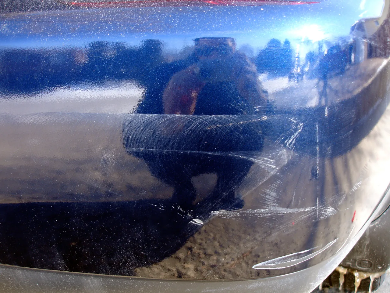 Local scuff and scratches on a blue rear bumper — example stock photo, not BumperFixers work